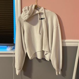 A white cropped hoodie with small black  heart